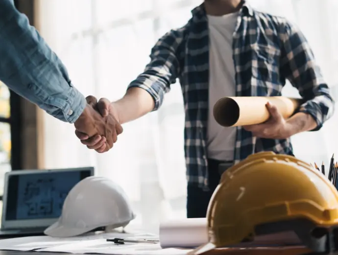 Vue rapprochée de l'équipe d'ingénierie se serrant la main une fois la transaction terminée. Planification d'équipe pour Archi